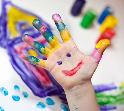 Little Children Hands doing Fingerpainting with various colors
